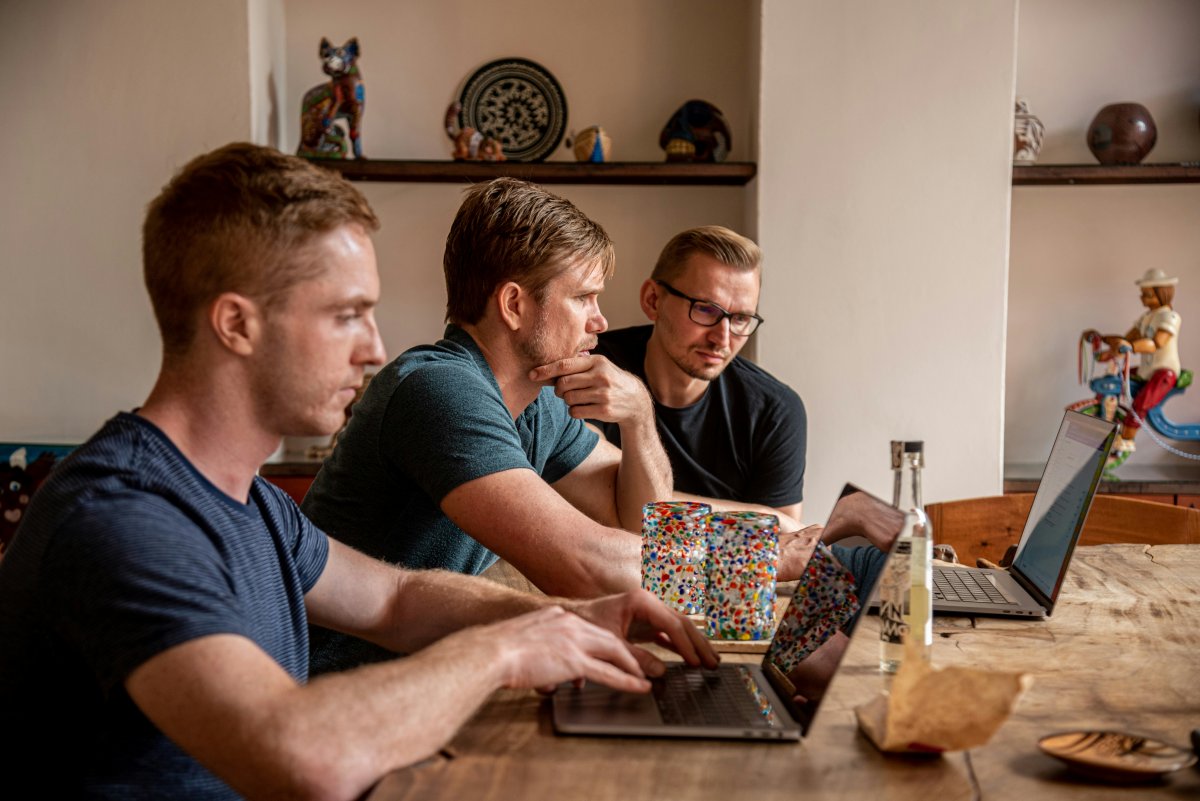 A group of people around laptops, working on the operations